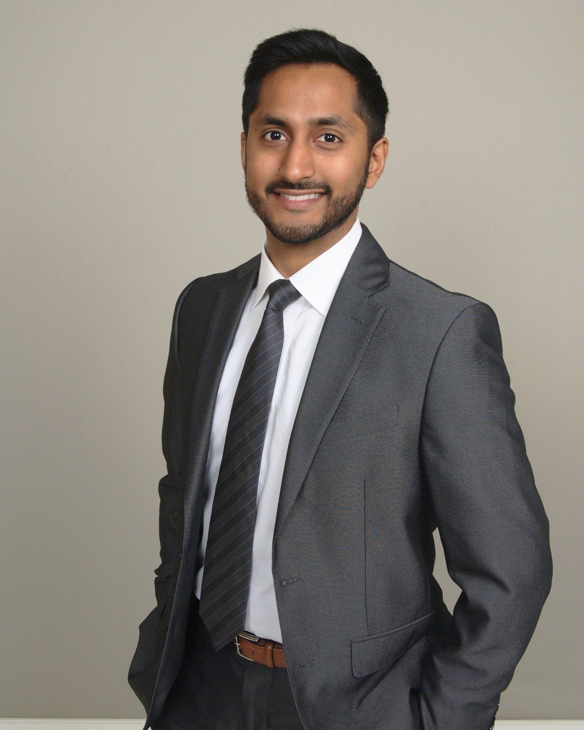 A professional photo of Dr. Sanjai Jalaj, in which he is wearing a grey suit